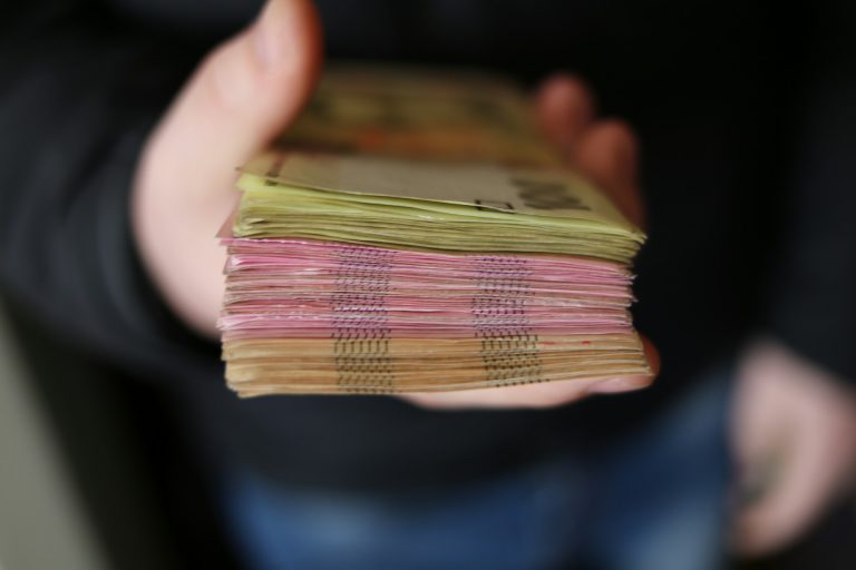 Hand handing over money