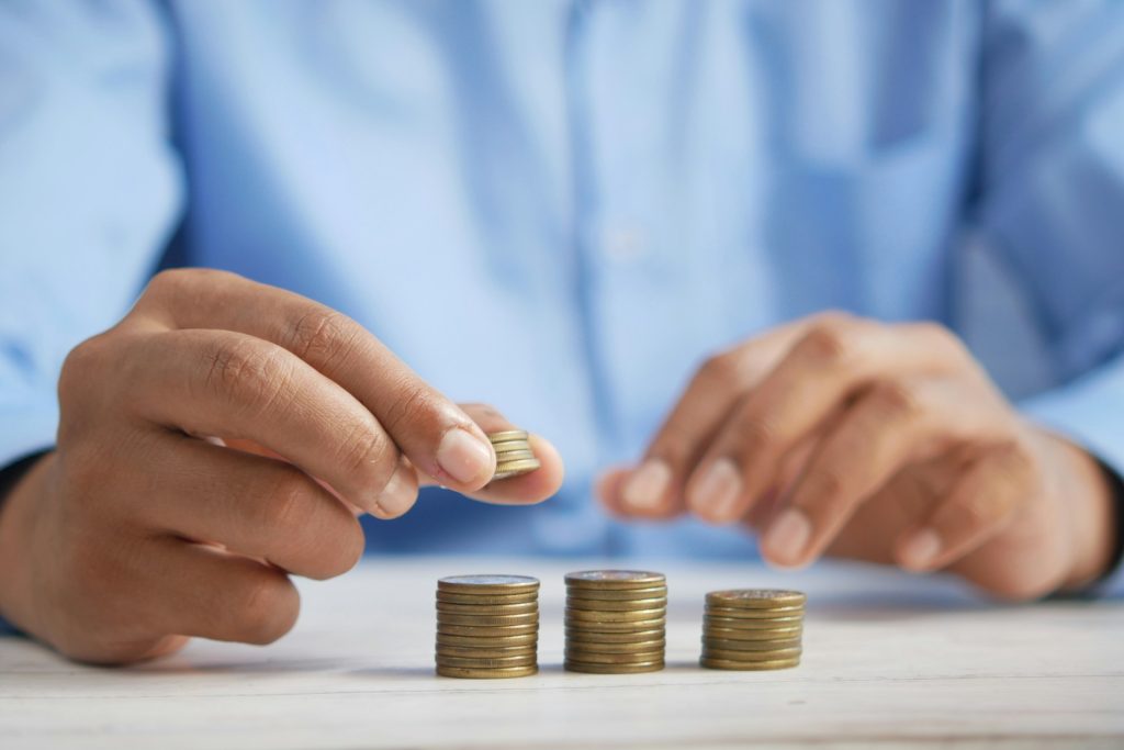 Male hands stacking coins